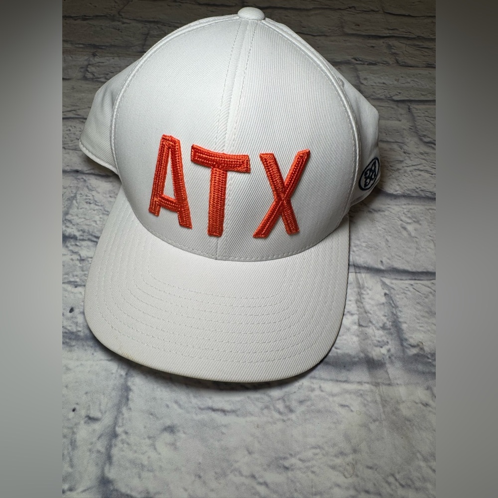 G/FORE ATX White SnapBack Cap with Orange Embroidery.